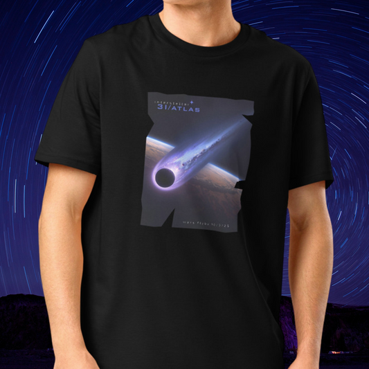 Person wearing a Stellarwear black organic cotton t-shirt with a space-themed graphic of 3I/ATLAS against a starry night sky background.