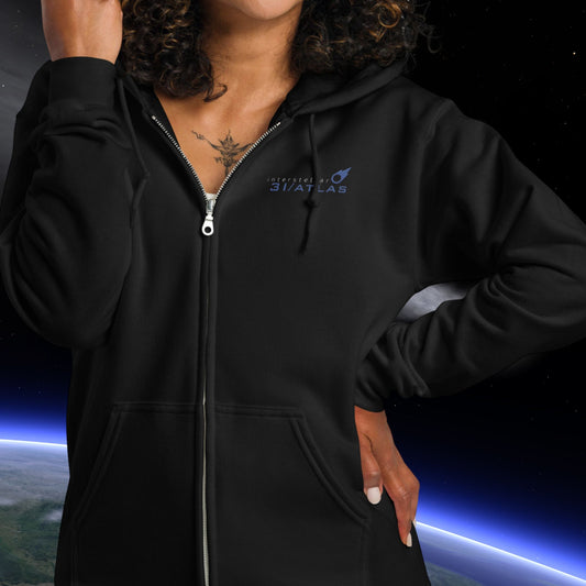 Person wearing a Stellarwear black hoodie with a 3I/ATLAS logo against a space-themed background