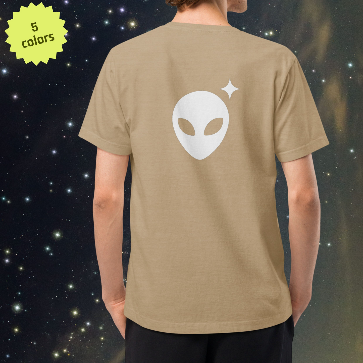 Person wearing a Stellarwear beige t-shirt with an Alienhead design on the back against a starry space background.