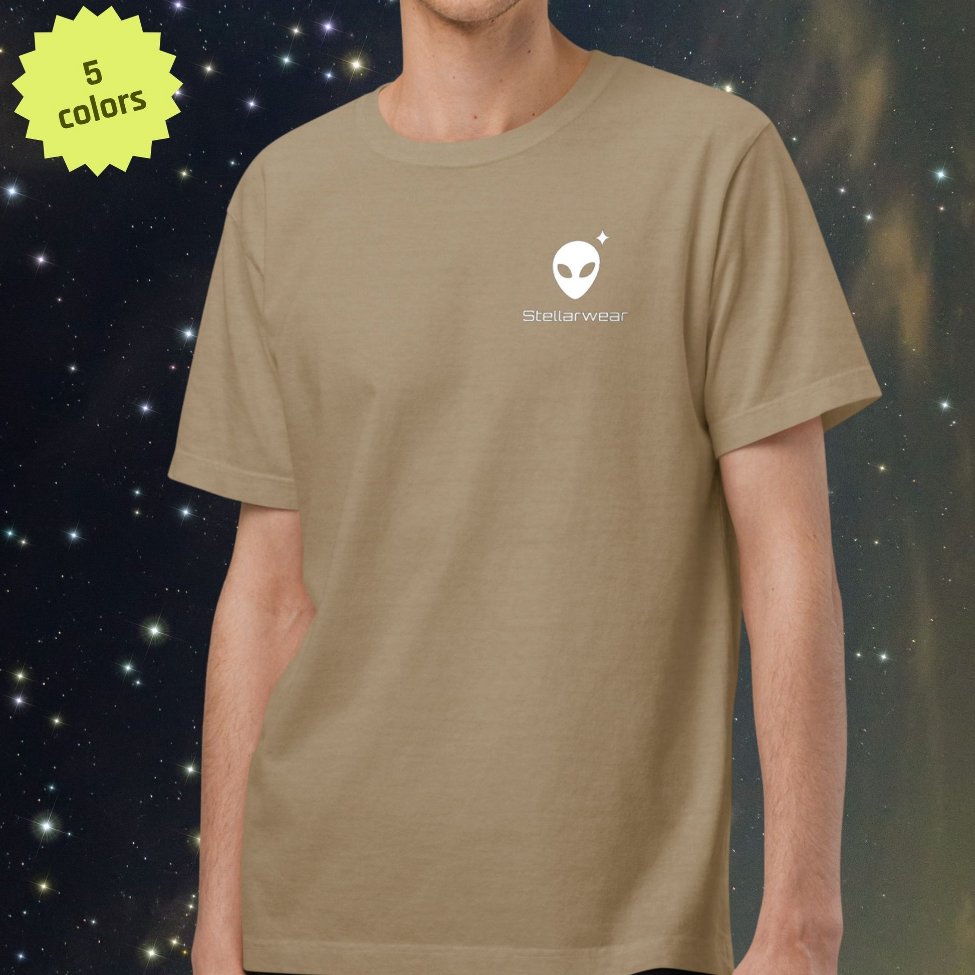 Person wearing a khaki Stellarwear t-shirt with an alien logo on a space-themed background