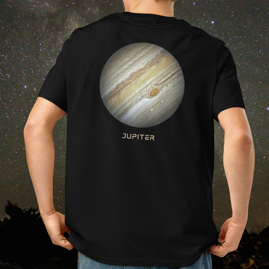Person wearing a black Stellarwear organic cotton t-shirt with a high resolution image of planet Jupiter against a starry sky background.