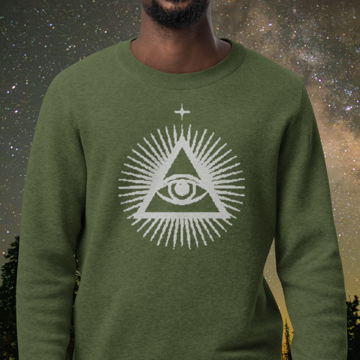 Green Stellarwear sweater with a white triangle eye design against a starry night sky background