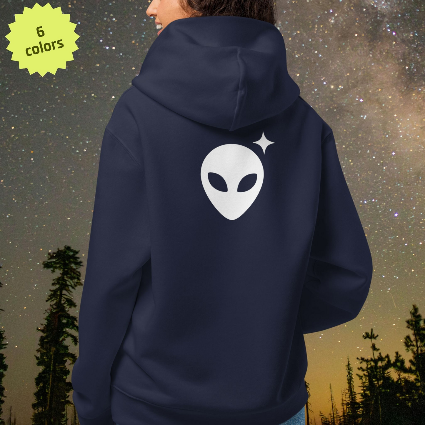 Navy blue Stellarwear hoodie with alien graphic on the back against a starry night sky.