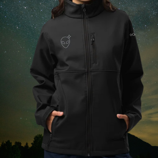 Person wearing a Stellarwear black jacket with an embroidered Alienhead against a night sky background.