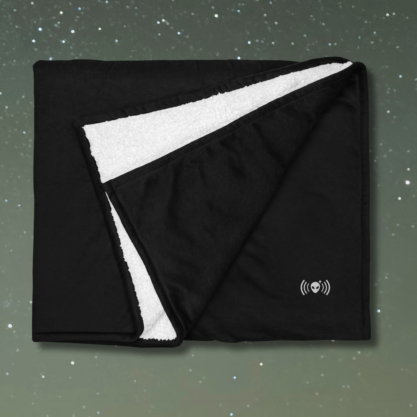 Stellarwear black and white blanket with alien logo on a starry sky background