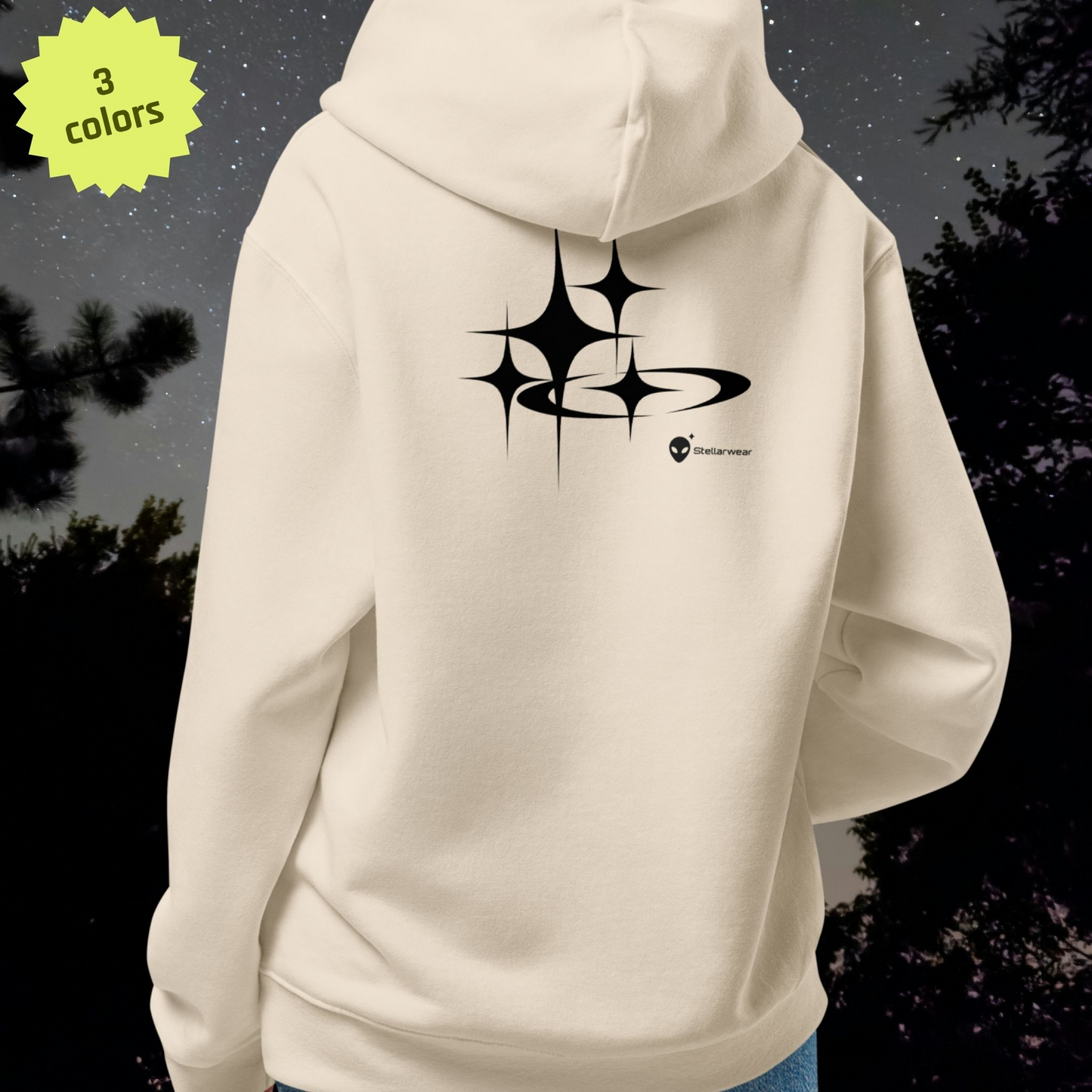 Beige Stellarwear hoodie with black star design on the back against a dark background