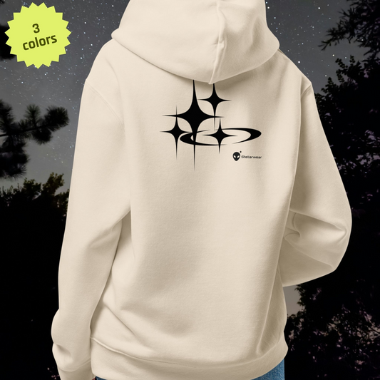 Beige Stellarwear hoodie with black star design on the back against a dark background