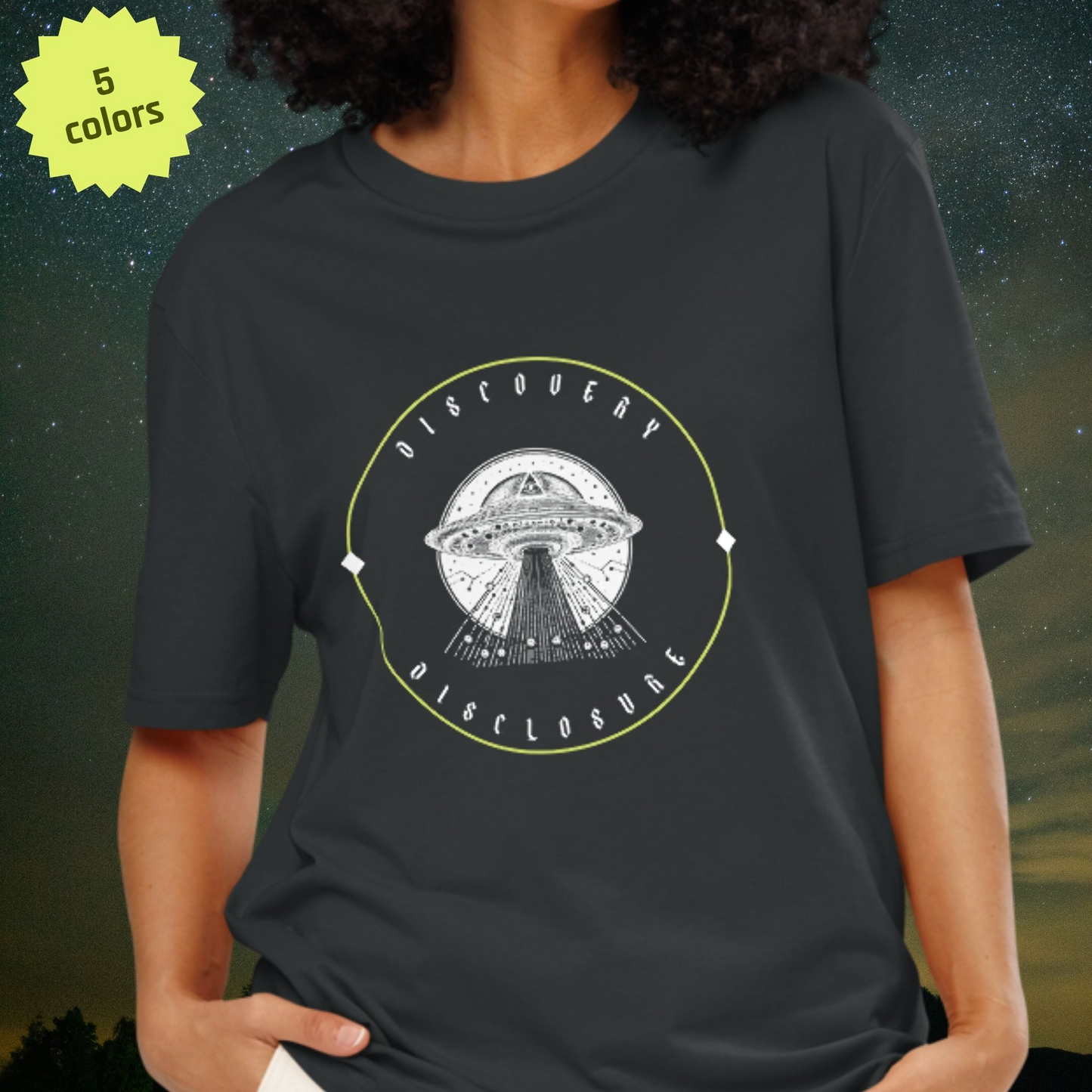 Person wearing a dark gray Stellarwear t-shirt with a UFO graphic and 'Discovery Disclosure' text on a starry night background.