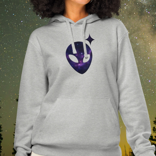 Person wearing a gray Stellarwear hoodie with a purple alien head design against a starry night sky.