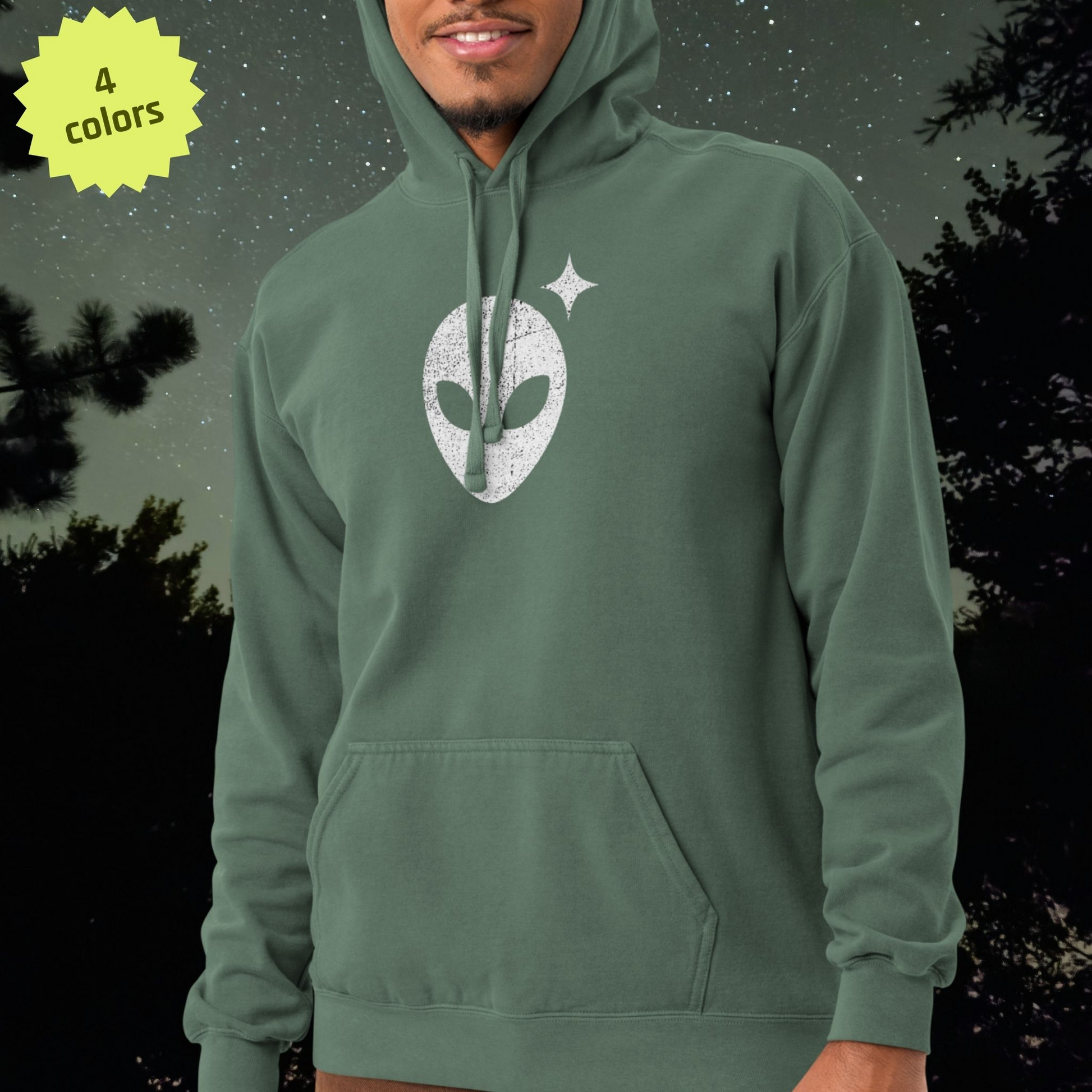 Person wearing a green Stellarwear hoodie with a white logo against a dark background