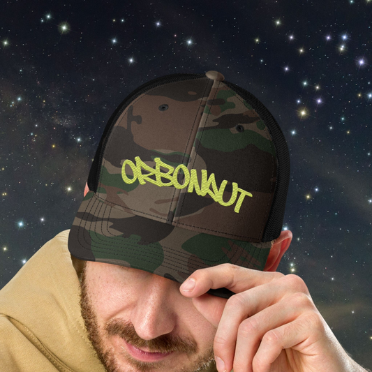 Person wearing a camouflage Stellarwear cap with 'OBONAUT' text against a starry night sky background