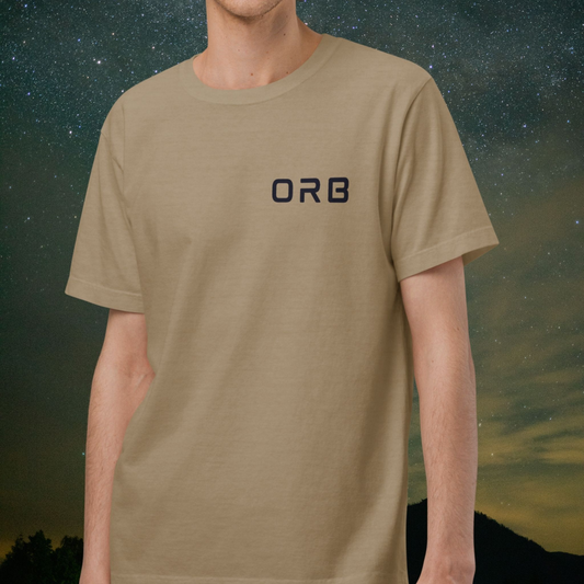 Person wearing a beige Stellarwear t-shirt with 'ORB' logo against a starry night sky background