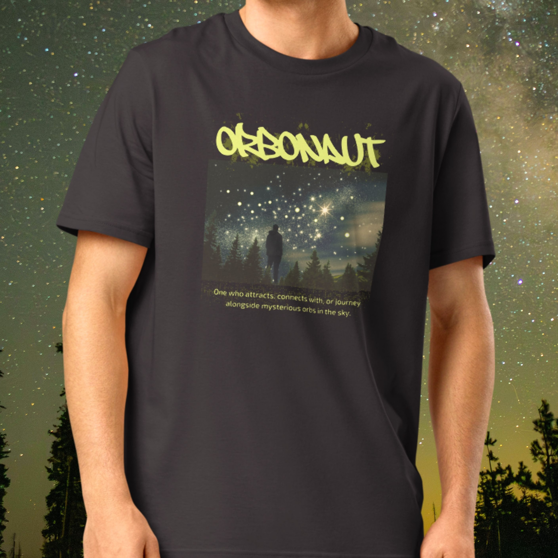 Person wearing a Stellarwear charcoal t-shirt with an orb graphic design and text against a starry night sky background.