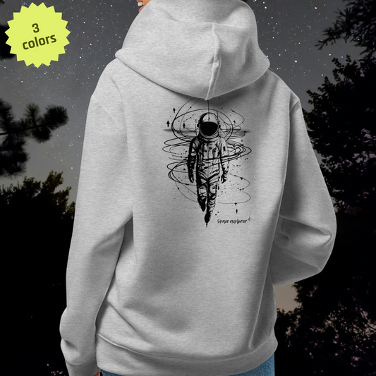 Gray Stellarwear hoodie with an astronaut design on the back, against a dark forest background.